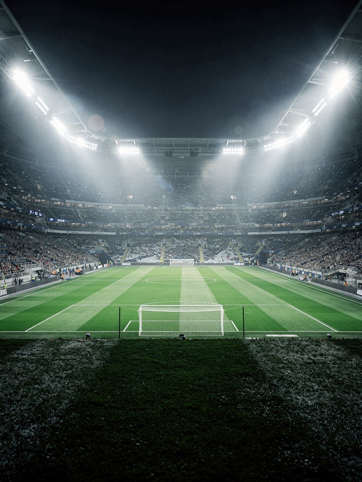 football stadium at night with floodlights illuminating green pitch, dramatic atmosphere