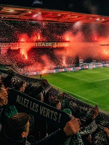 football_supporters_in_a_smaller_stadium_waving_scarves