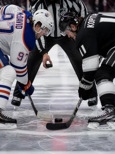 ice_hockey_players_facing_off_at_center_ice_close_up