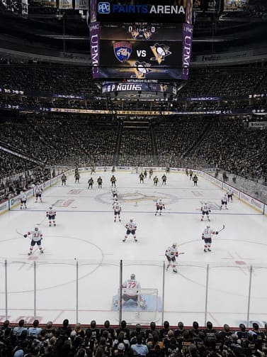 packed_ice_hockey_stadium_with_dramatic_lighting_and_two_team